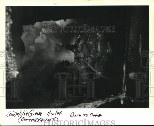 1994 Press Photo Firefighters shown using the hose to put out the fire - Historic Images