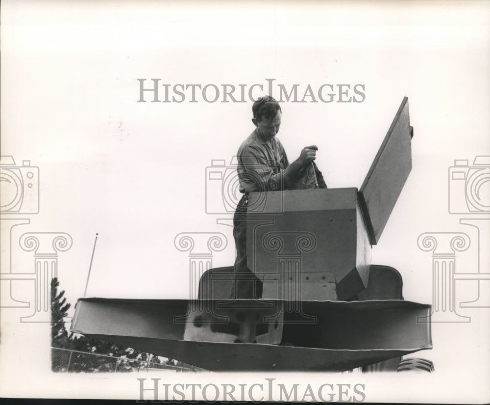 1963 Press Photo Farmer pouring grain into a hopper. - nob10773-Historic Images