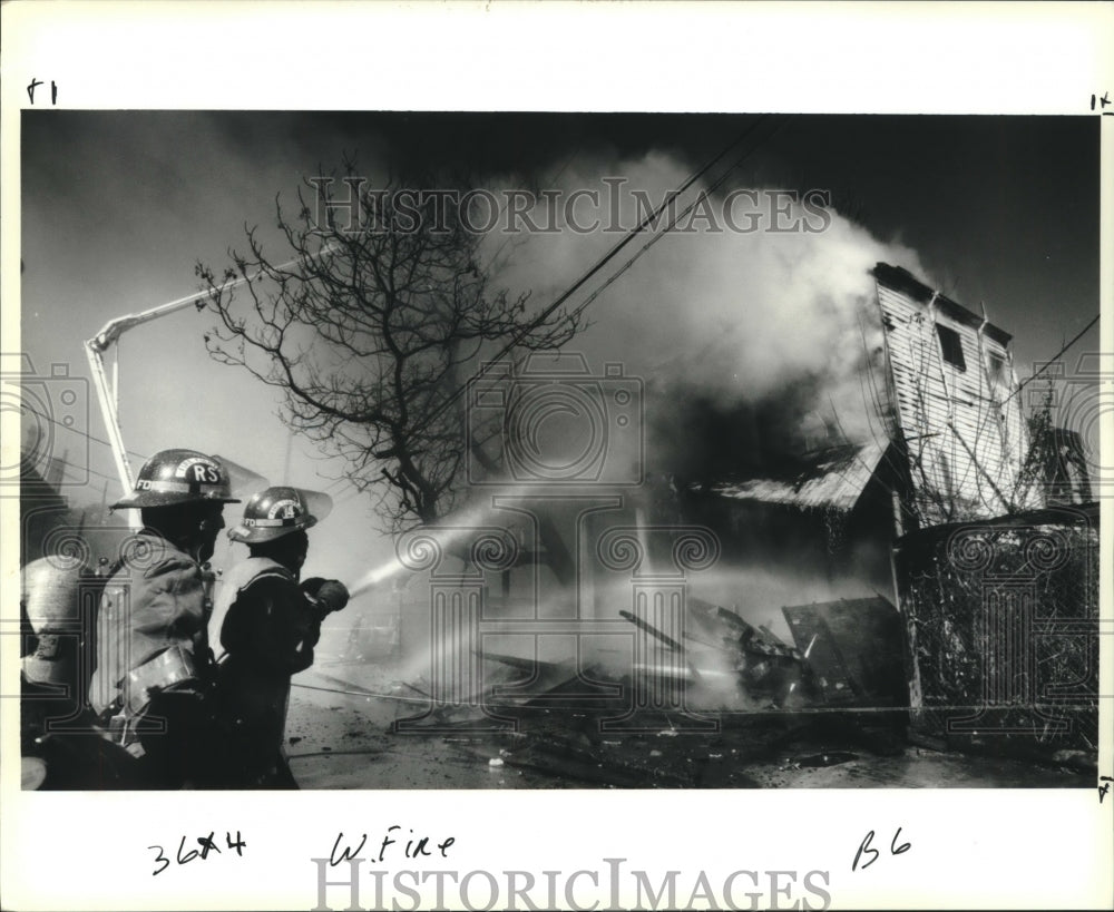 1991 Press Photo New Orleans Firemen extinguishing fire on1100 block, Melpomene - Historic Images