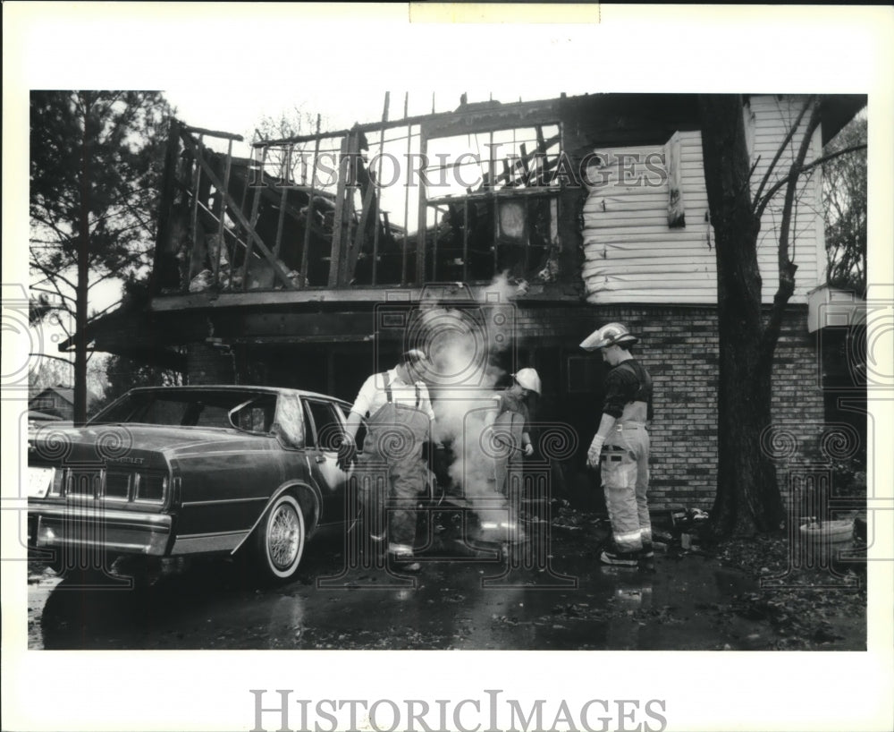 1991 Press Photo Marrero Estelle Volunteer Firemen douse fire on Champagne St. - Historic Images