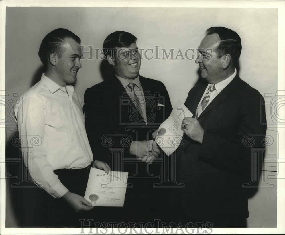 1969 Bufford Fillingame presents certificates of graduation to men - Historic Images