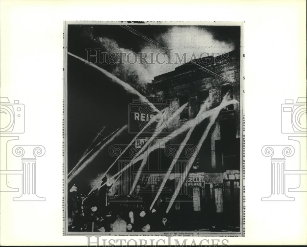 1937 Press Photo Fireworks ignited as firemen battle a fire at James J. Reiss Co - Historic Images