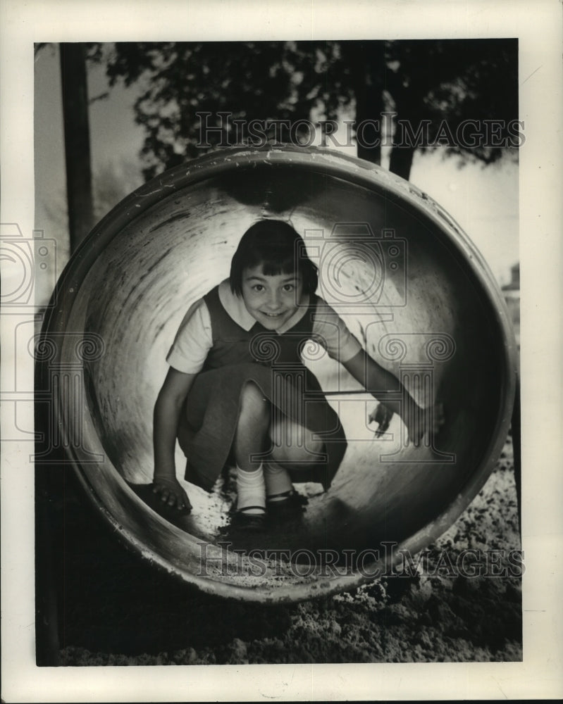 1964 Denis Oubre at the barrel on the Ganus School playground - Historic Images