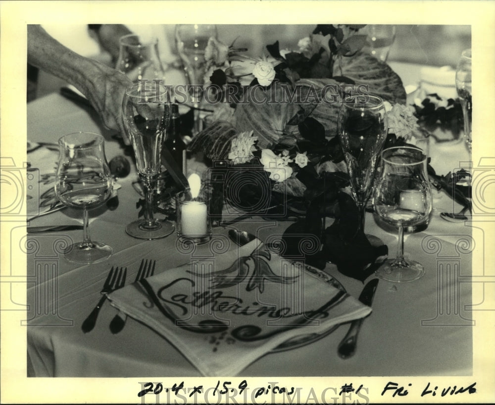 1992 Press Photo A lady lights a candle in a completed table in the back garden - Historic Images