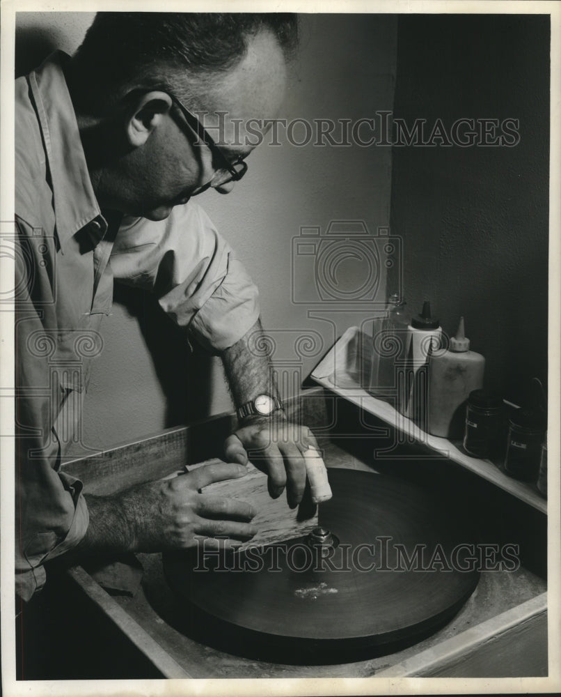 1961 Press Photo A.P. Richard smoothing surface of a petrified wood - nob17702 - Historic Images