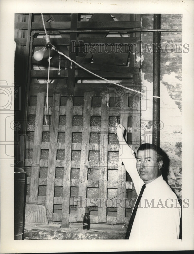 1957 Press Photo John Gentilich shows a broken wooden window - nob17743 - Historic Images