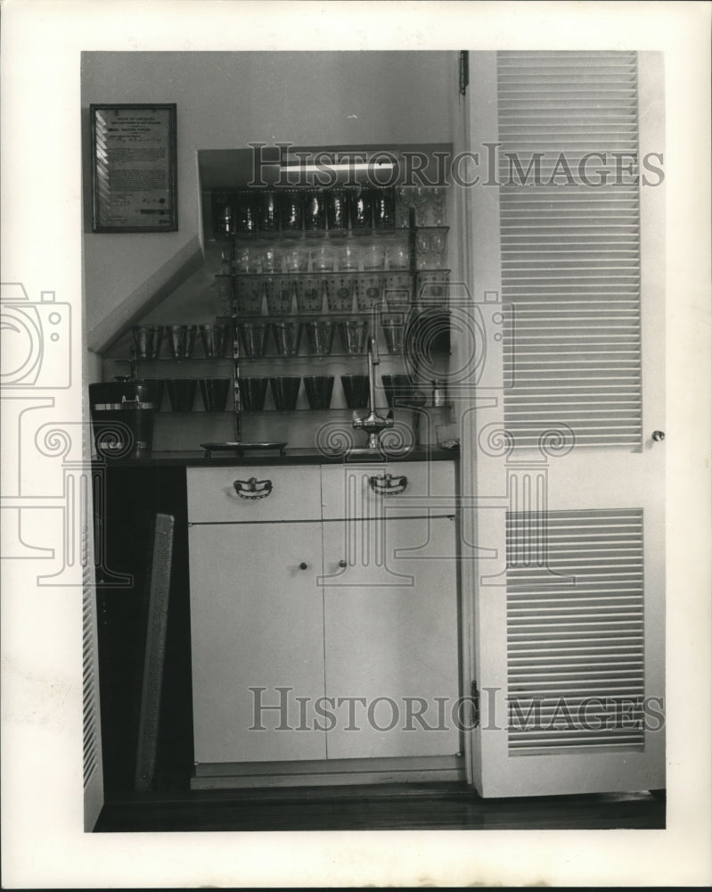 1963 Press Photo Card table storage is hidden behind lower doors in living room. - Historic Images