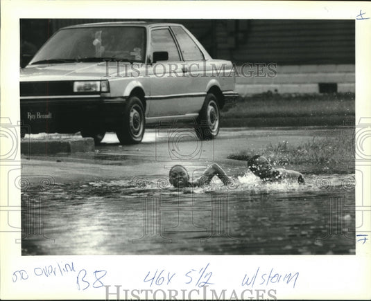 1992 Press Photo Flooding-Kelly & Aubrey swim their way down Hagan Street - Historic Images