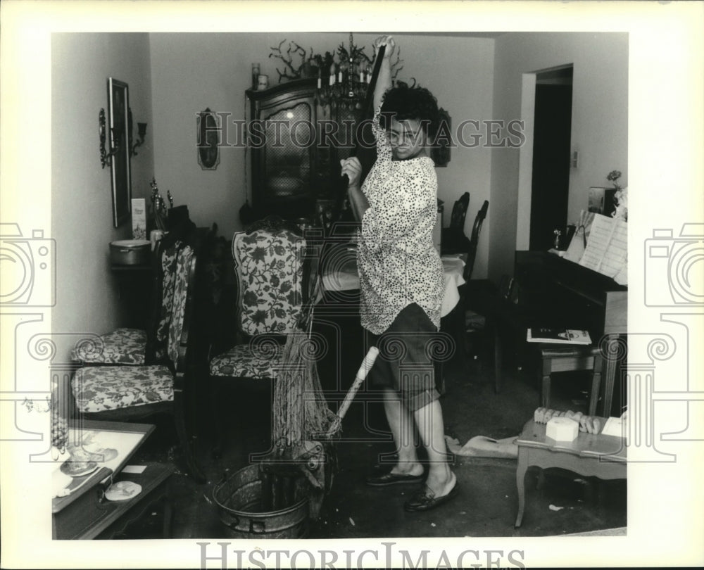 1990 Flooding- Elizabeth Rosemore cleans water from her living room - Historic Images