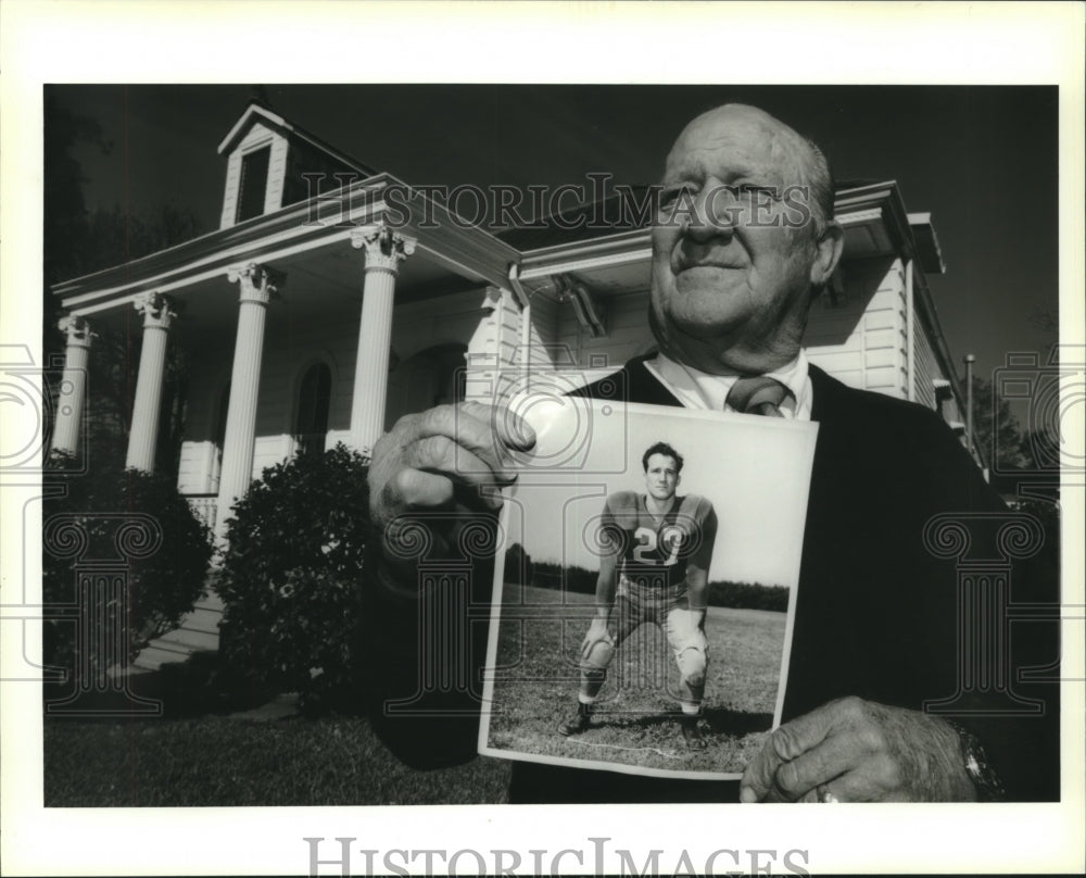 1995 Press Photo Don Fortier holds his football days photo at Tulane - Historic Images