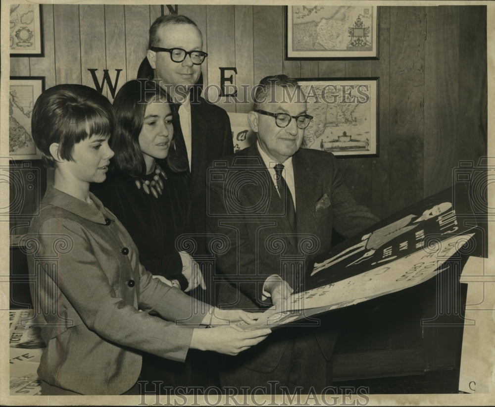 1966 Press Photo Dr. Ronald George looks over posters, Times Picayune-Historic Images