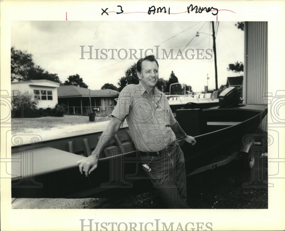 1990 Press Photo Tim George of Tim&#39;s Marine Inc. stands in front of Jon boat - Historic Images