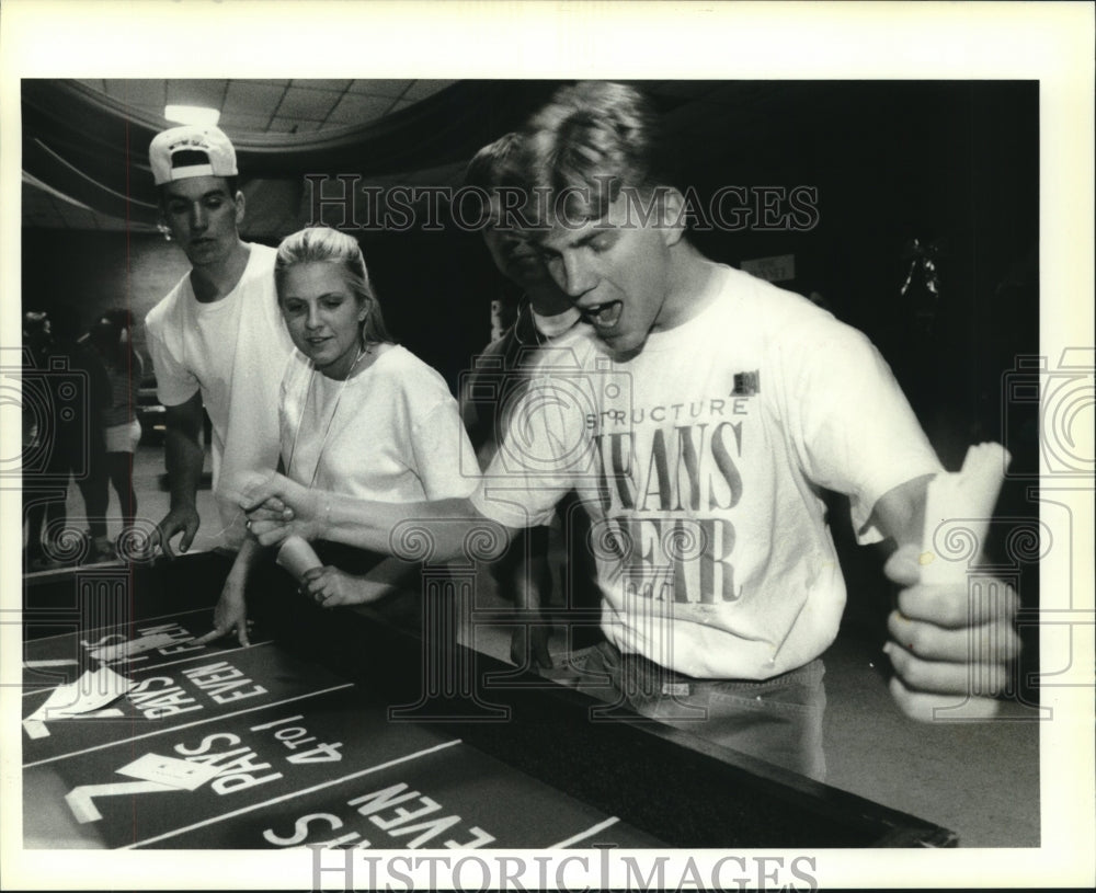 1994 Press Photo Jeff Glynn throws lucky roll during graduation party - Historic Images