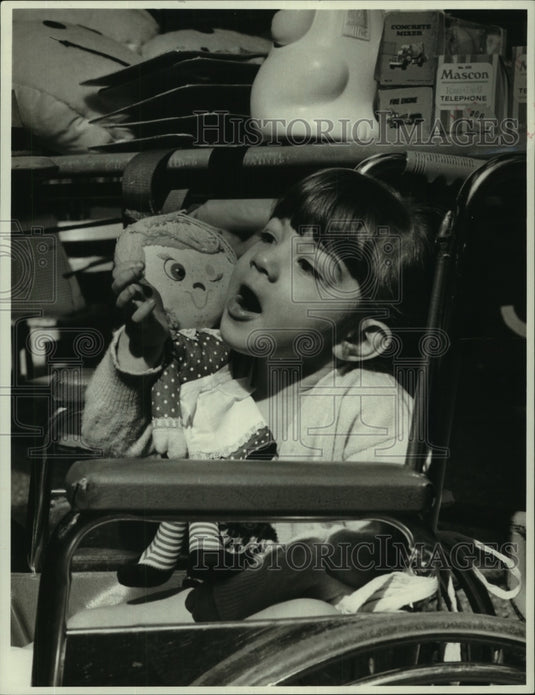 1972  Nadine Giudroz sits with her doll in hospital - Historic Images