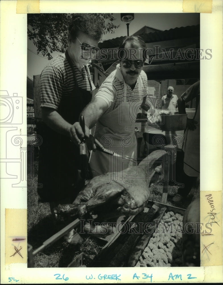 1989 Press Photo Greek Festival participants baste one of the 110 lambs - Historic Images