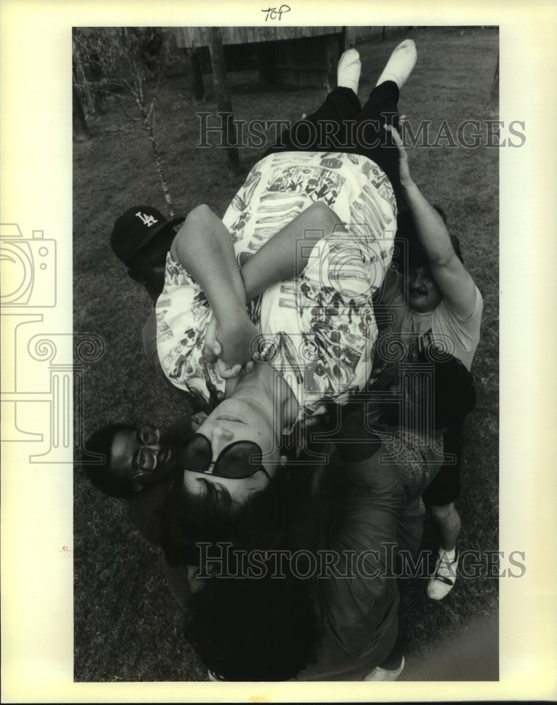 1989 Press Photo Janet Guillory held aloft, at trust workshop, St. John Parish - Historic Images