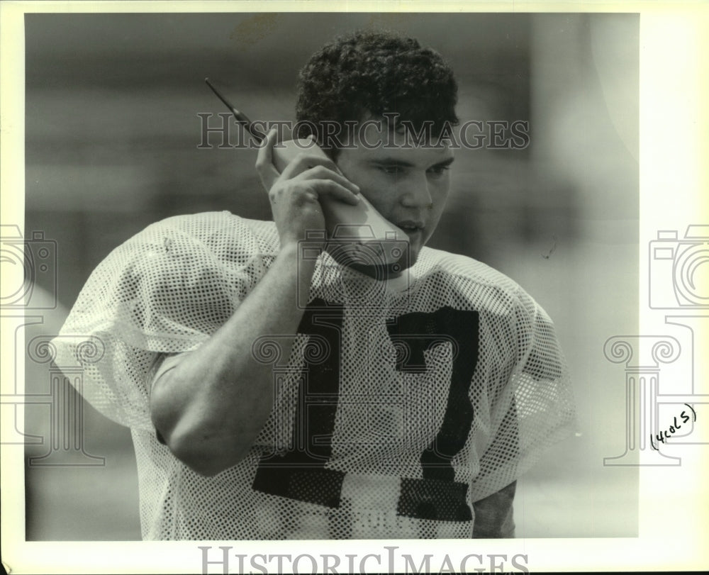 1992 Press Photo Mickey Guidry takes a call during practice at John Curtis High - Historic Images