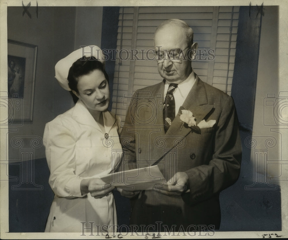 1953 Press Photo Dr. James Graves in his office with nurse Beverly Mitchell - Historic Images