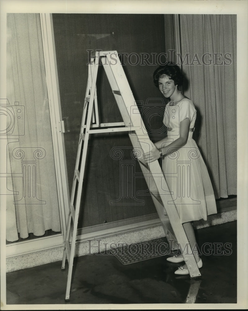 1962 Gail Gravolet prepares to use a ladder - Historic Images