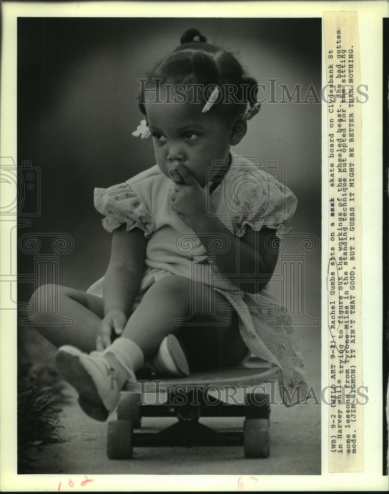 1988 Press Photo Rachel Gumbs sits on a skate board on Clydesbank Street - Historic Images