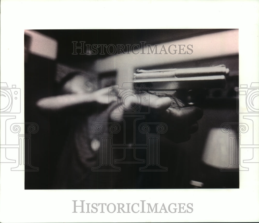 1993 Press Photo Kids and guns-A young person holding a handgun - nob24160 - Historic Images