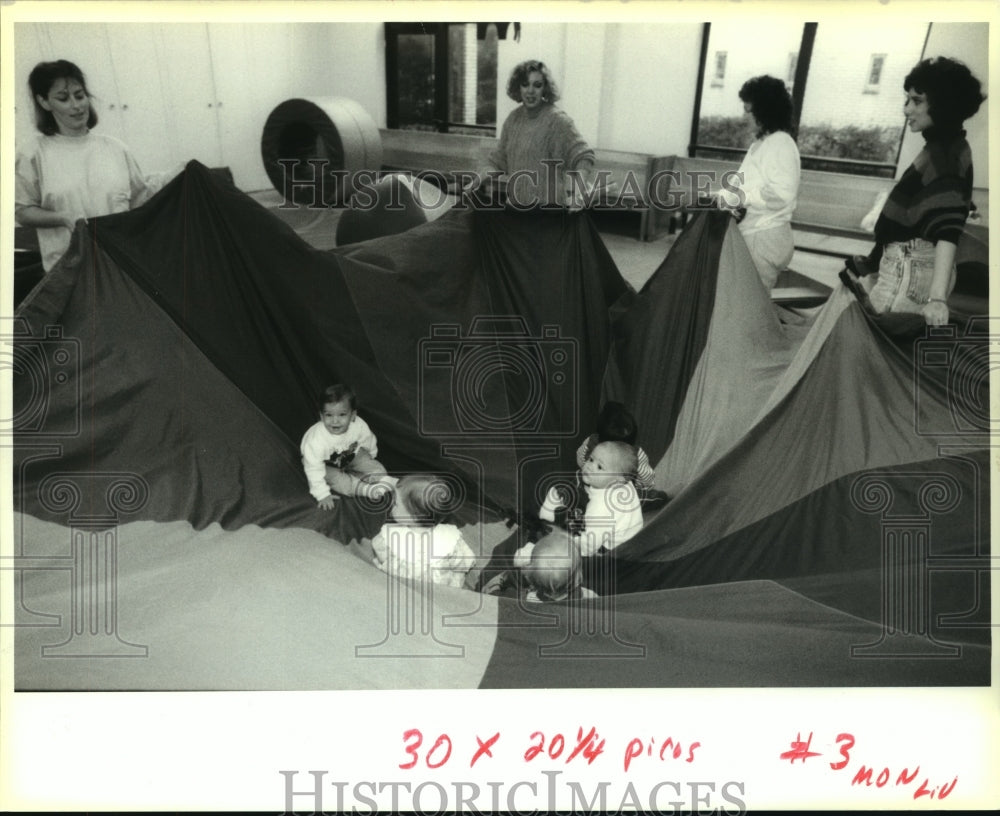 1992 Press Photo Adults play a parachute and son game at Gym Rompers class - Historic Images