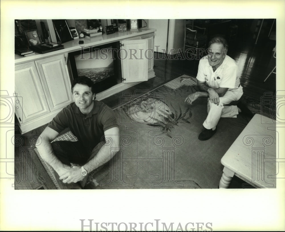 1995 Press Photo Keith Guy and George R. Guy sit on top of a hand painted sisal - Historic Images