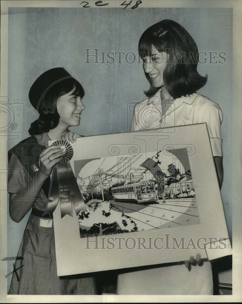 1965 Girl Scout Barbara Kennedy and Marilynn Felts hold the collage - Historic Images