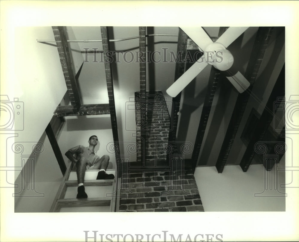 1995 Press Photo Steven Hal sits in unfinished loft that he uses for storage - Historic Images