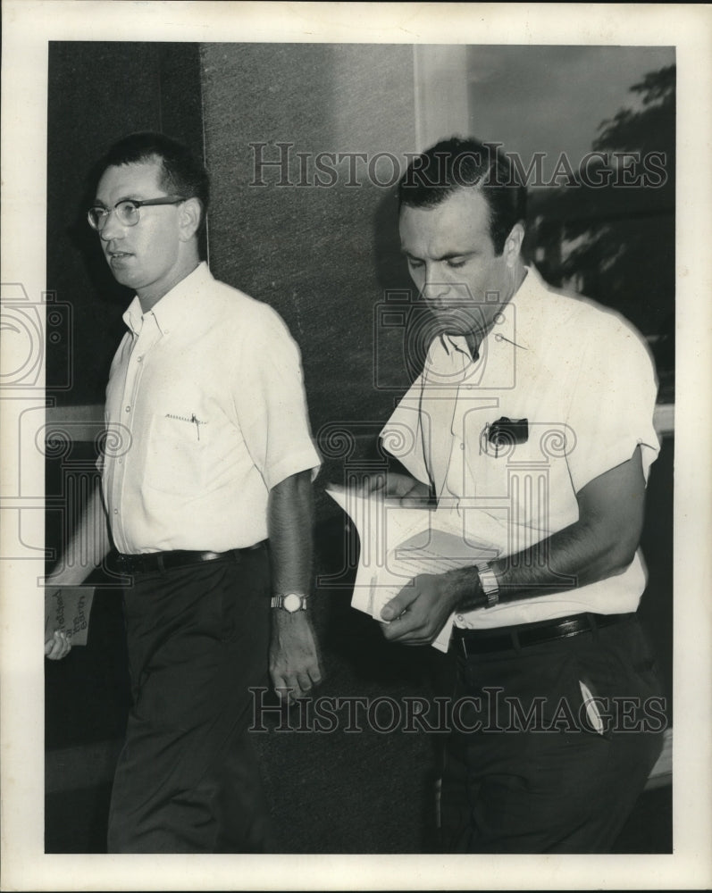 Press Photo Mr. Haggard flips through some documents - nob26247 - Historic Images