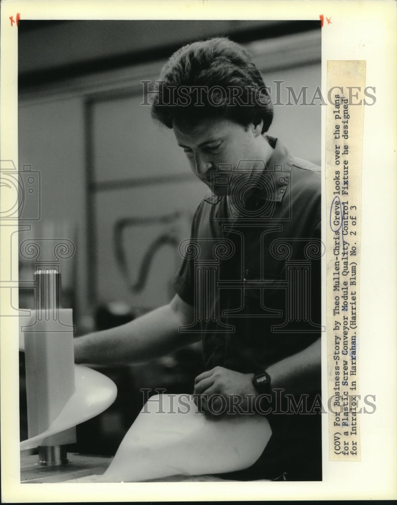 1988 Chris Greve looks over plans for Plastic Screw Conveyor Module - Historic Images