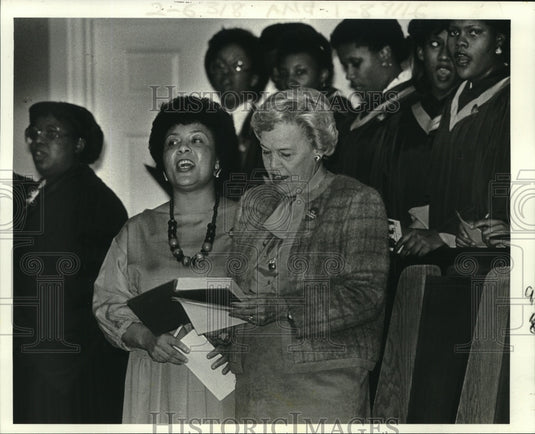 Gail Glapion sings with retiring board president Elizabeth Rack. - Historic Images
