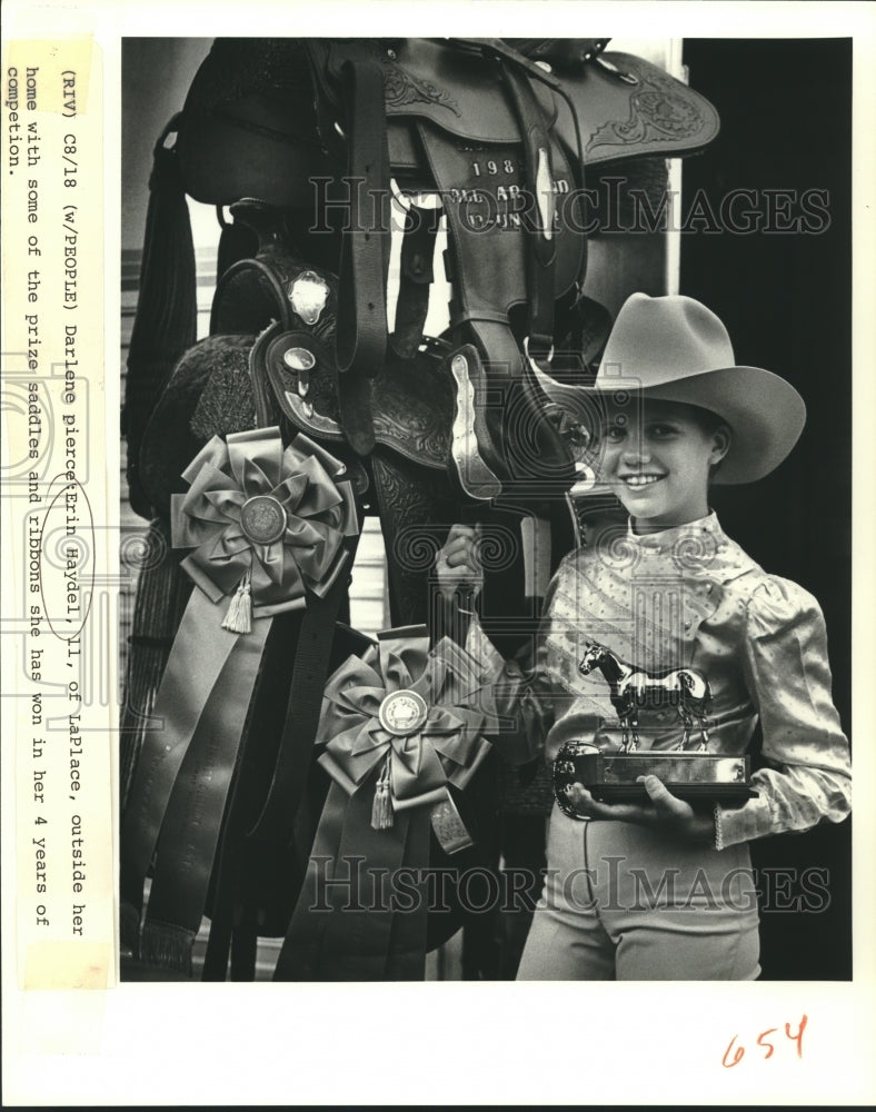 1988 Press Photo Erin Haydel, 11, of LaPlace, displays her prize saddles/ribbons - Historic Images