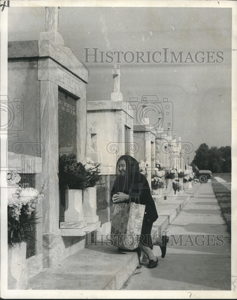 1970 Mrs. Josefina Gioe visits family graves at Greenwood Cemetery - Historic Images