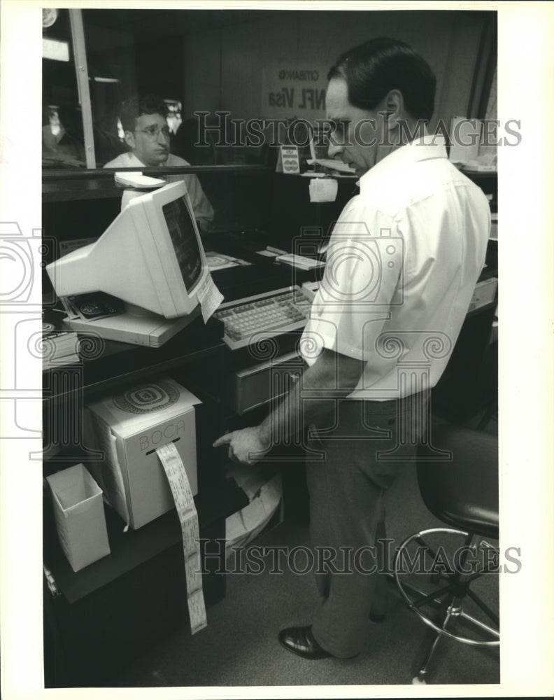 1991 Press Photo Harvey Hanley watches Saints at the ticket office in Superdome - Historic Images