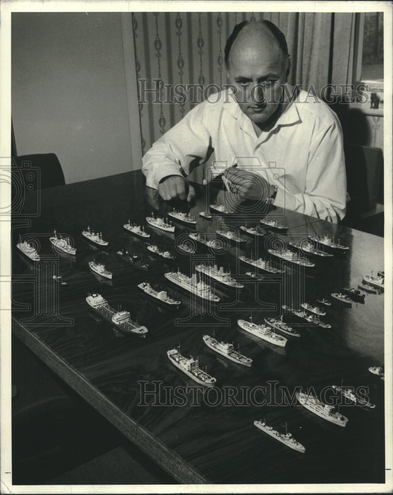 1971 A man shown with several dozens of his model ships in a fleet - Historic Images