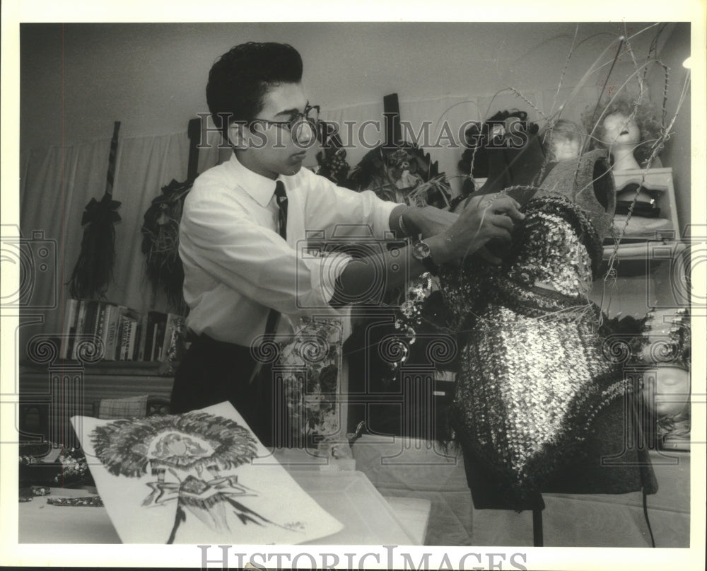 1992 Press Photo Roy Haylock works on a costume he designed for Mary West - Historic Images