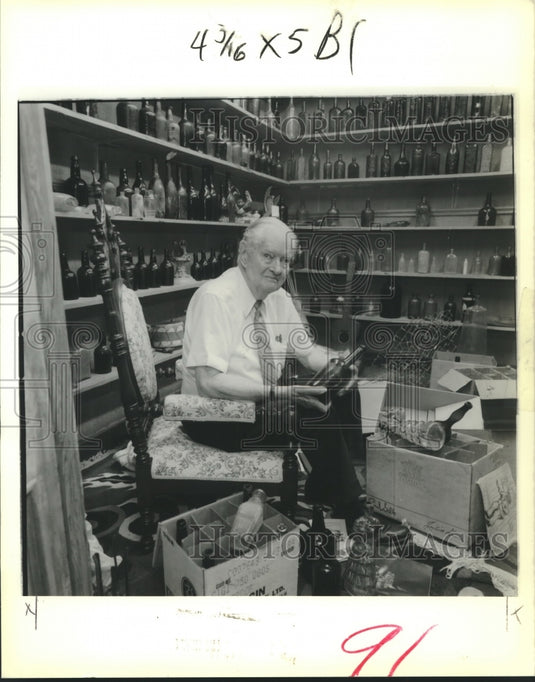 1989 William Groves sits among part of his glass collection - Historic Images