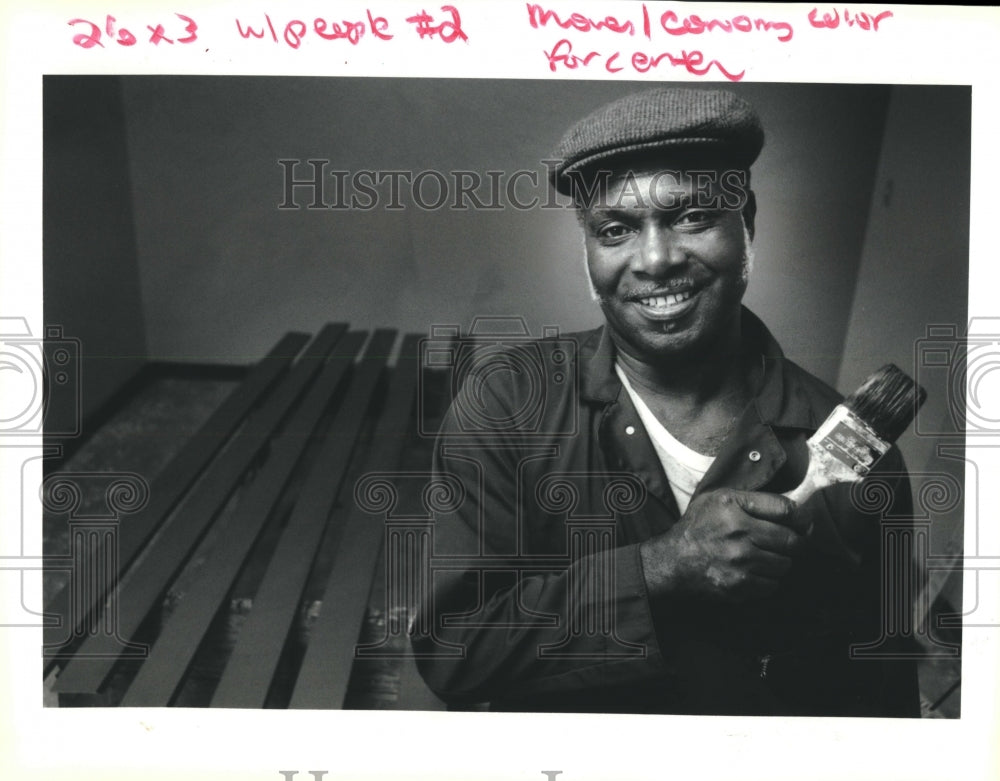 1992 Leroy A. Harper paints baseboards at an apartment in Metairie - Historic Images