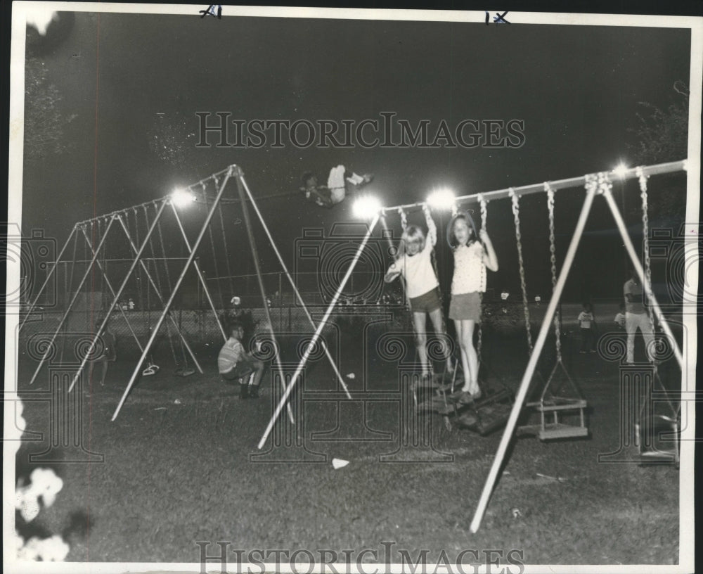 1967 Kids Play On Swingsets At Night In Glow Of New Lighting System-Historic Images