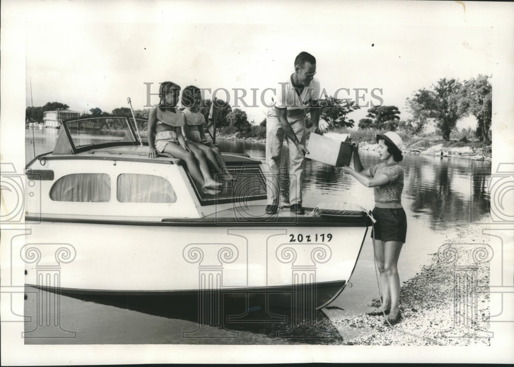 Captain Bruce Hall and family loading supplies to their boat - Historic Images