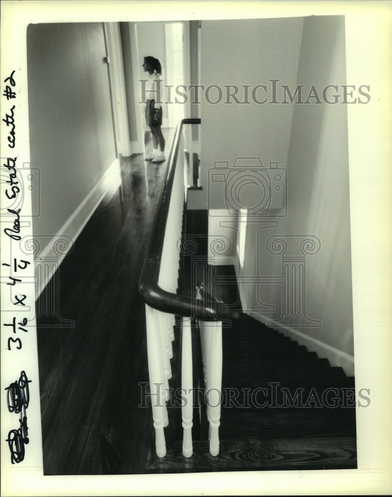 1990 Pam Harnett stands in hallway of home built to look Victorian. - Historic Images