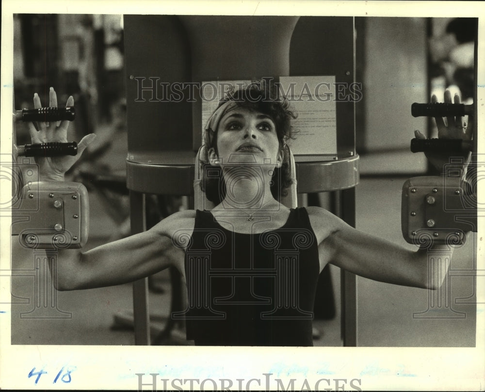 1985 Julie Tupler uses Nautilus machine at Heritage Sports Center - Historic Images