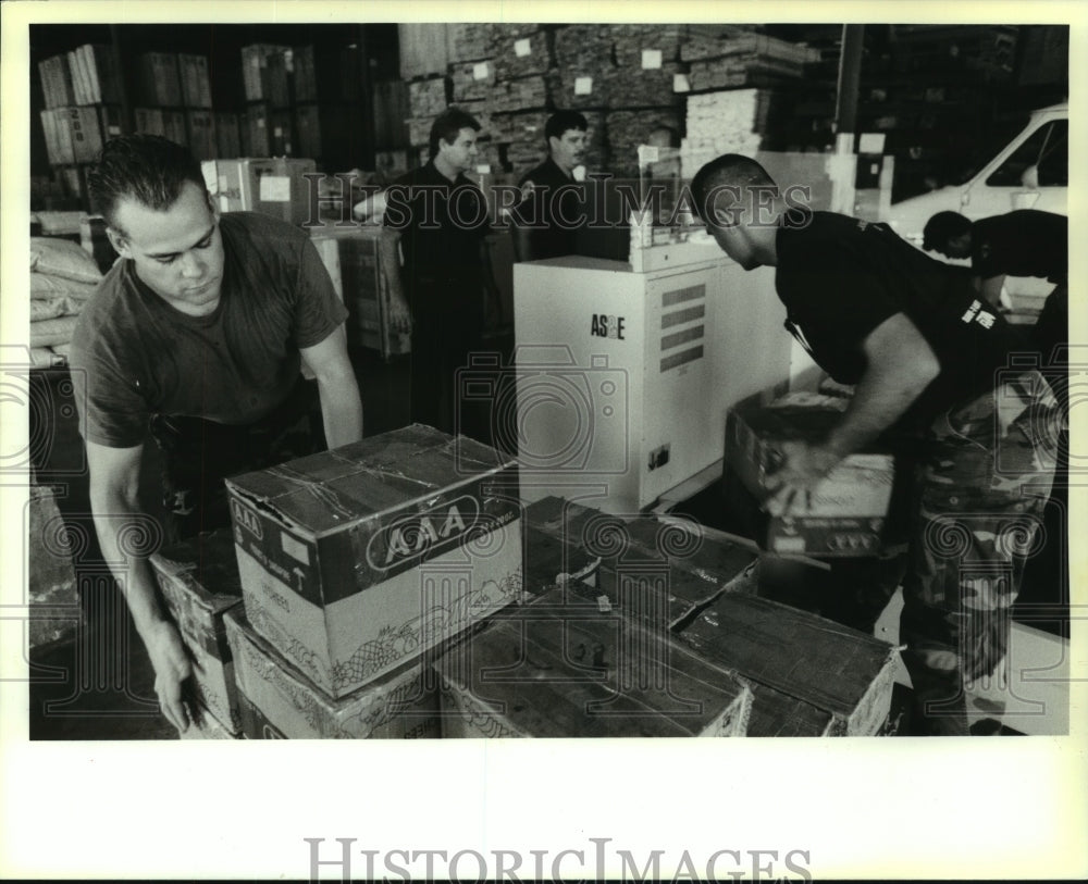 1993 Press Photo Louisiana National Guards inspect cases of cans for heroin - Historic Images