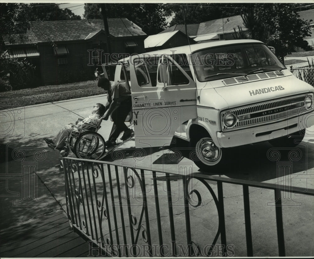 1973 Press Photo Disabled person in wheelchair assisted to get in Handicab-Historic Images