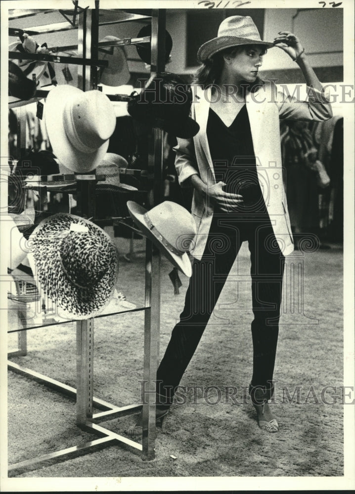 1979 Trudy Chatelain headlines her jeans suit with a Western hat. - Historic Images