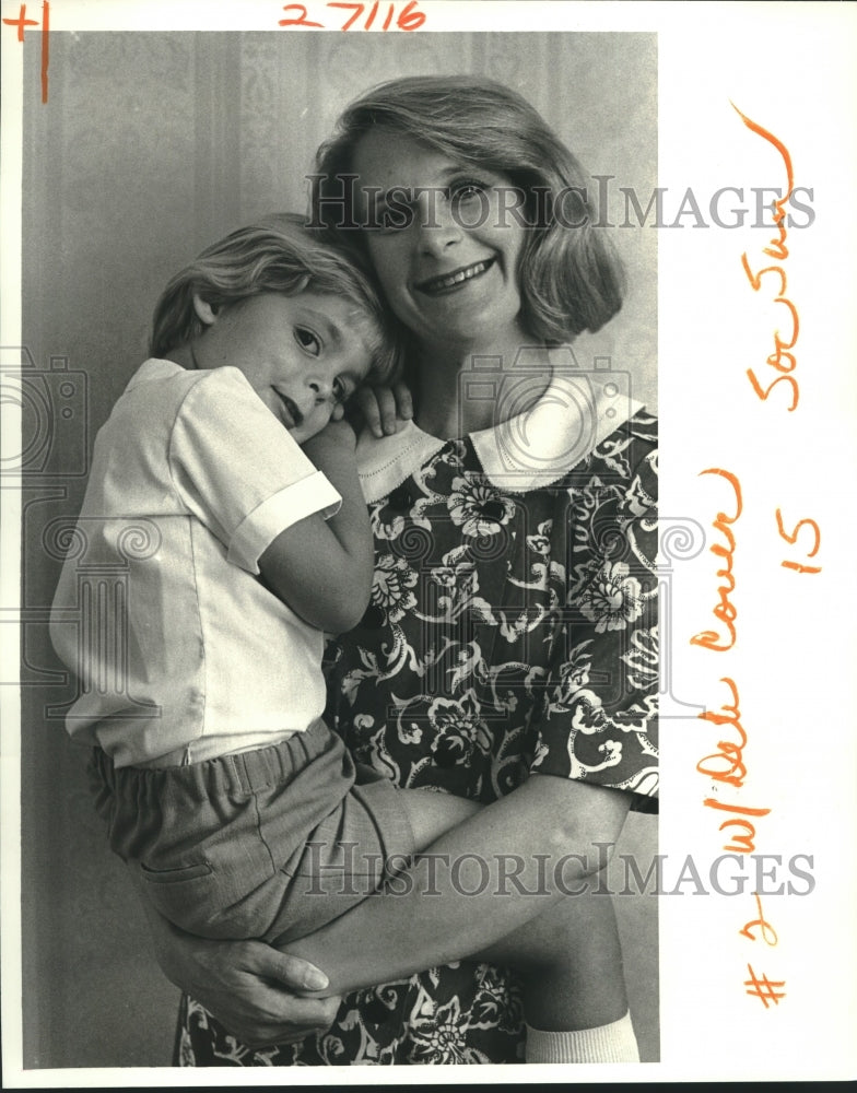 1987 Ann Harbison holds her son Medlock Harbison on State Street - Historic Images