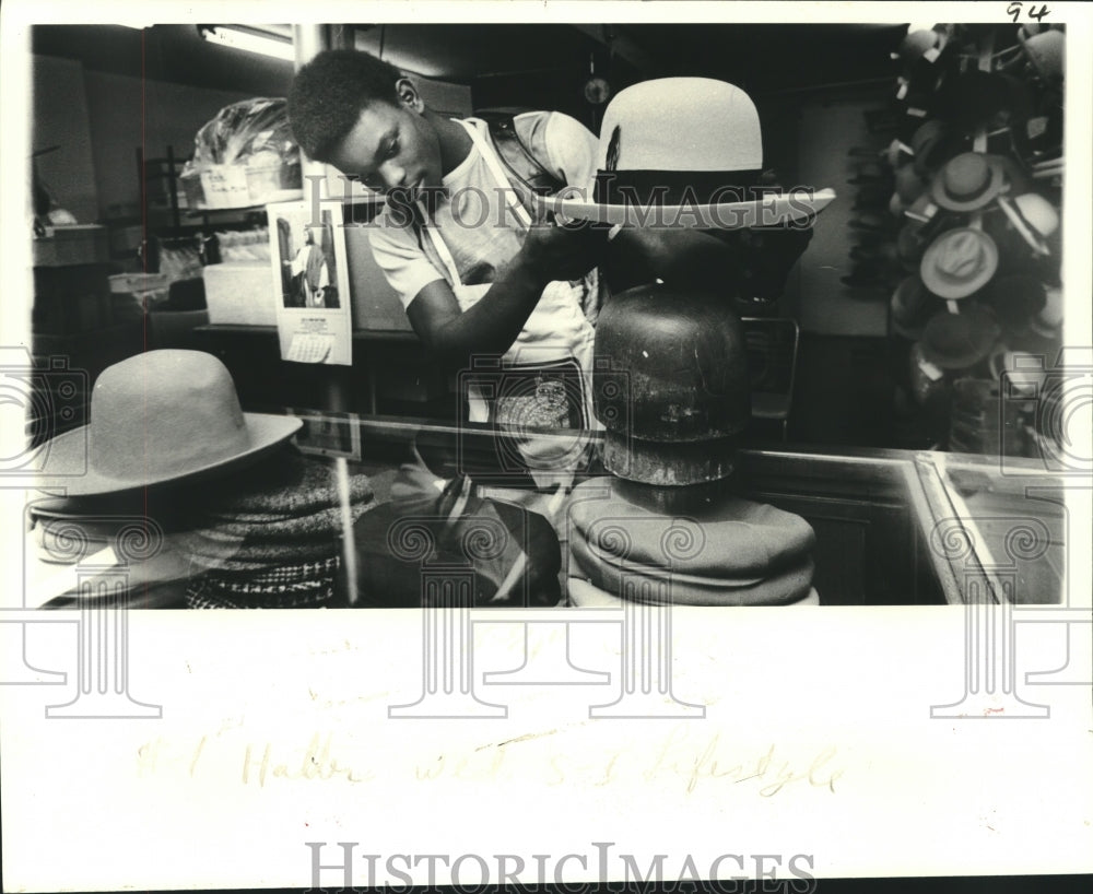 1979 Junius Harris demonstrates part of the art of cleaning a hat - Historic Images