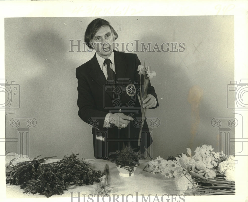 1979 Claude Harwood demonstrates flower arranging. - Historic Images