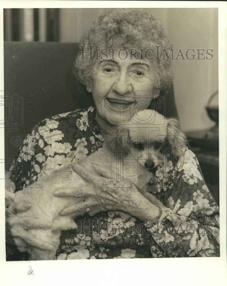 1990 Marie Henak enjoys the company of her dog Beau Jacques - Historic Images